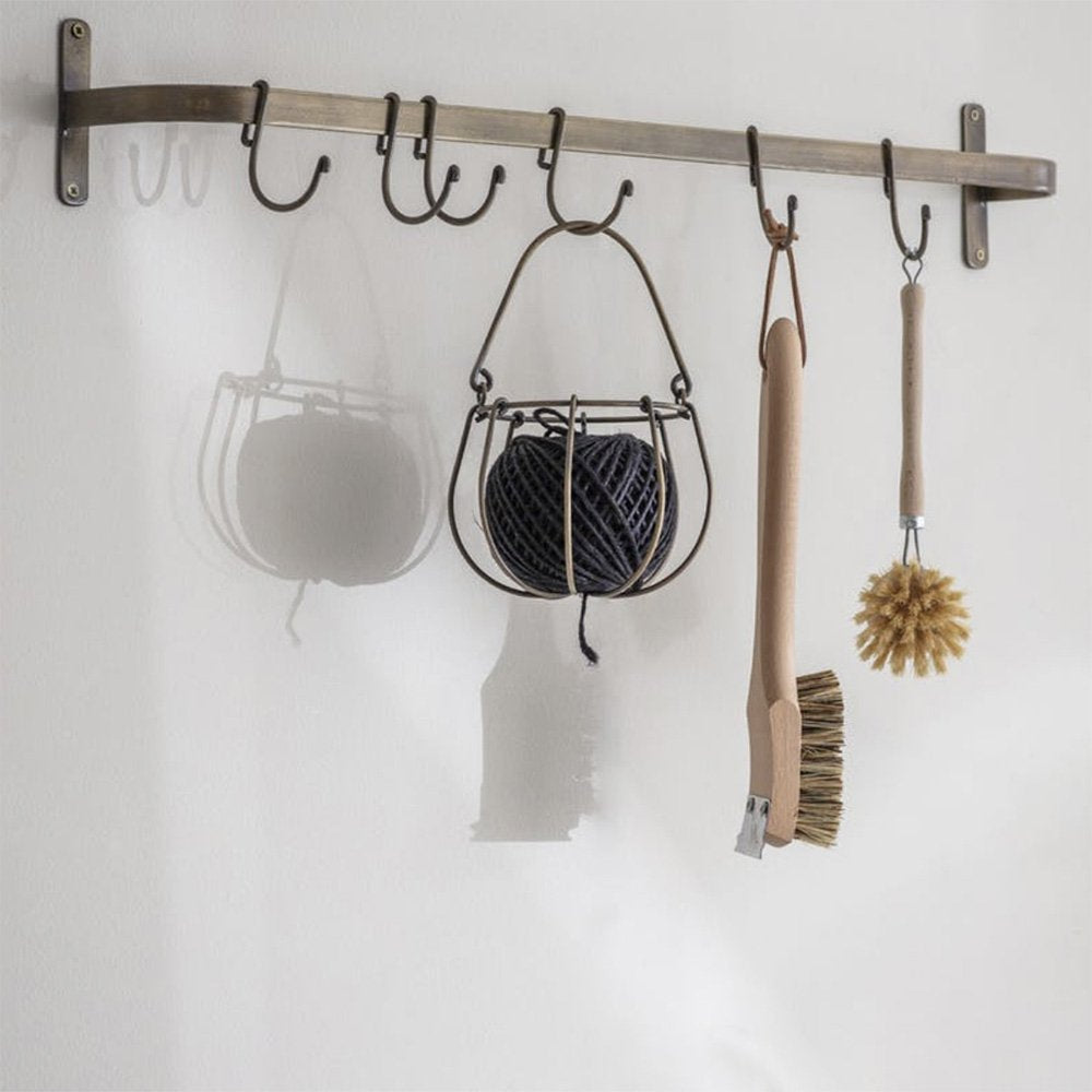 Antique bronze hook rail with items hanging from hooks