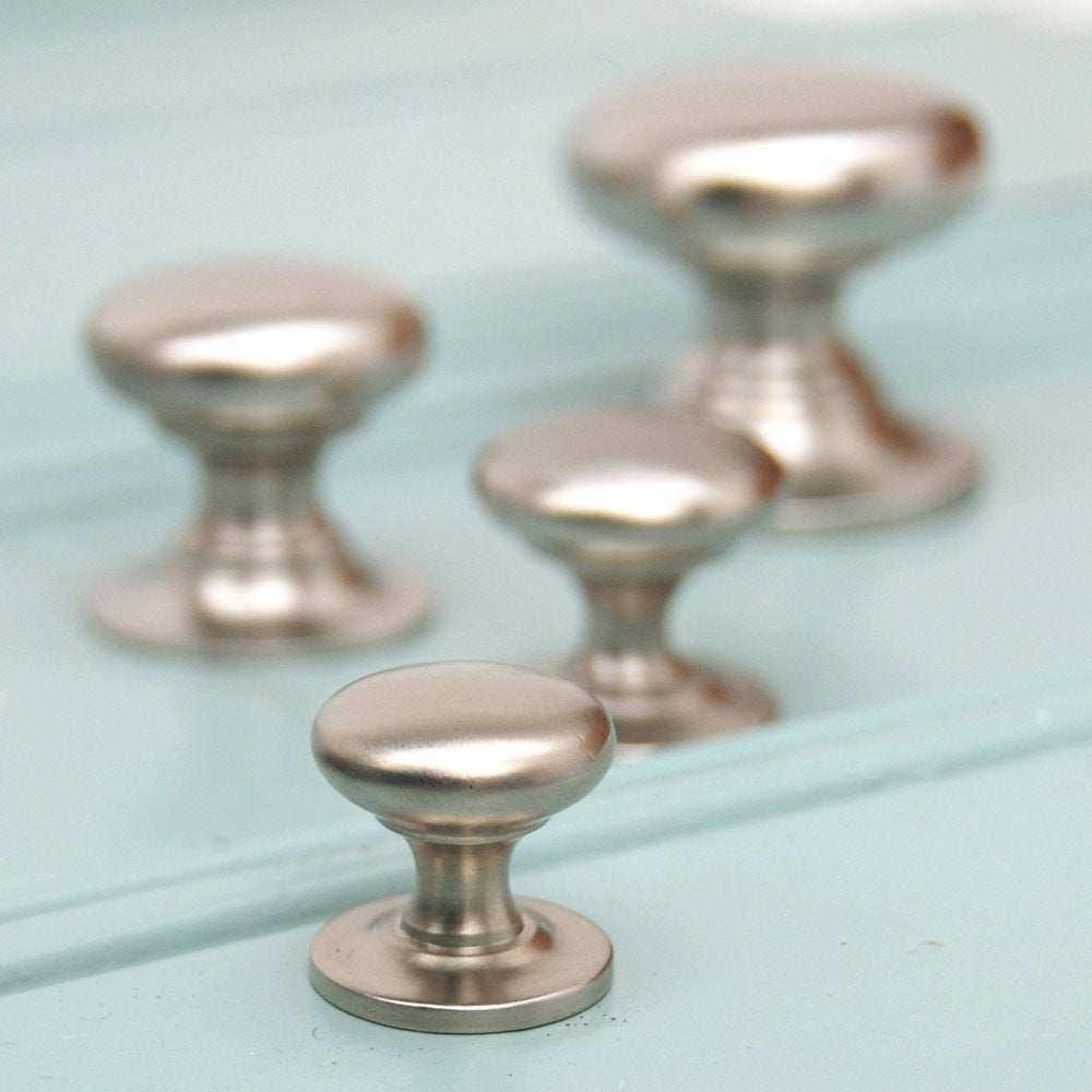 Solid brass Cabinet Knobs in Satin Nickel plated finish, sizes ascending from front.
