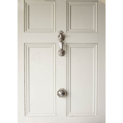 Satin Nickel Doctors Door Knocker and Pointed Octagonal Door Pull on white door.