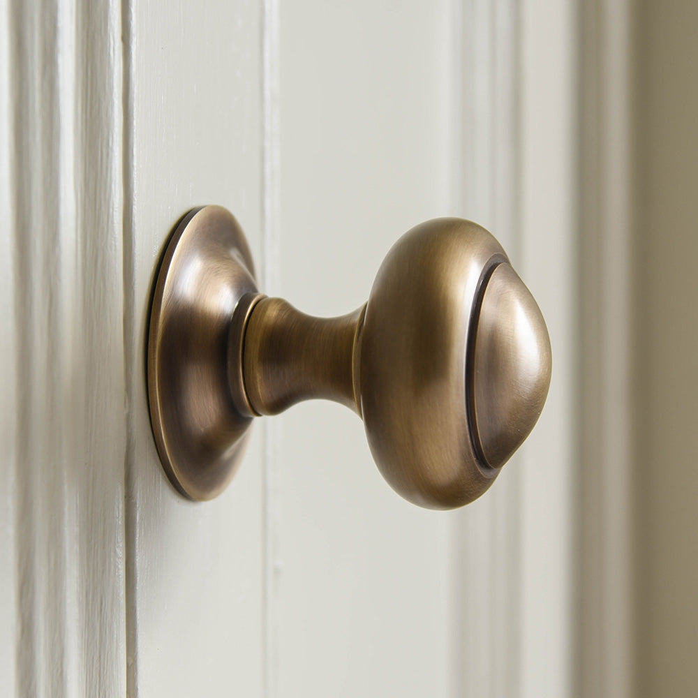 Side view of solid brass Round 3 inch Door Pull in Light Antique finish.