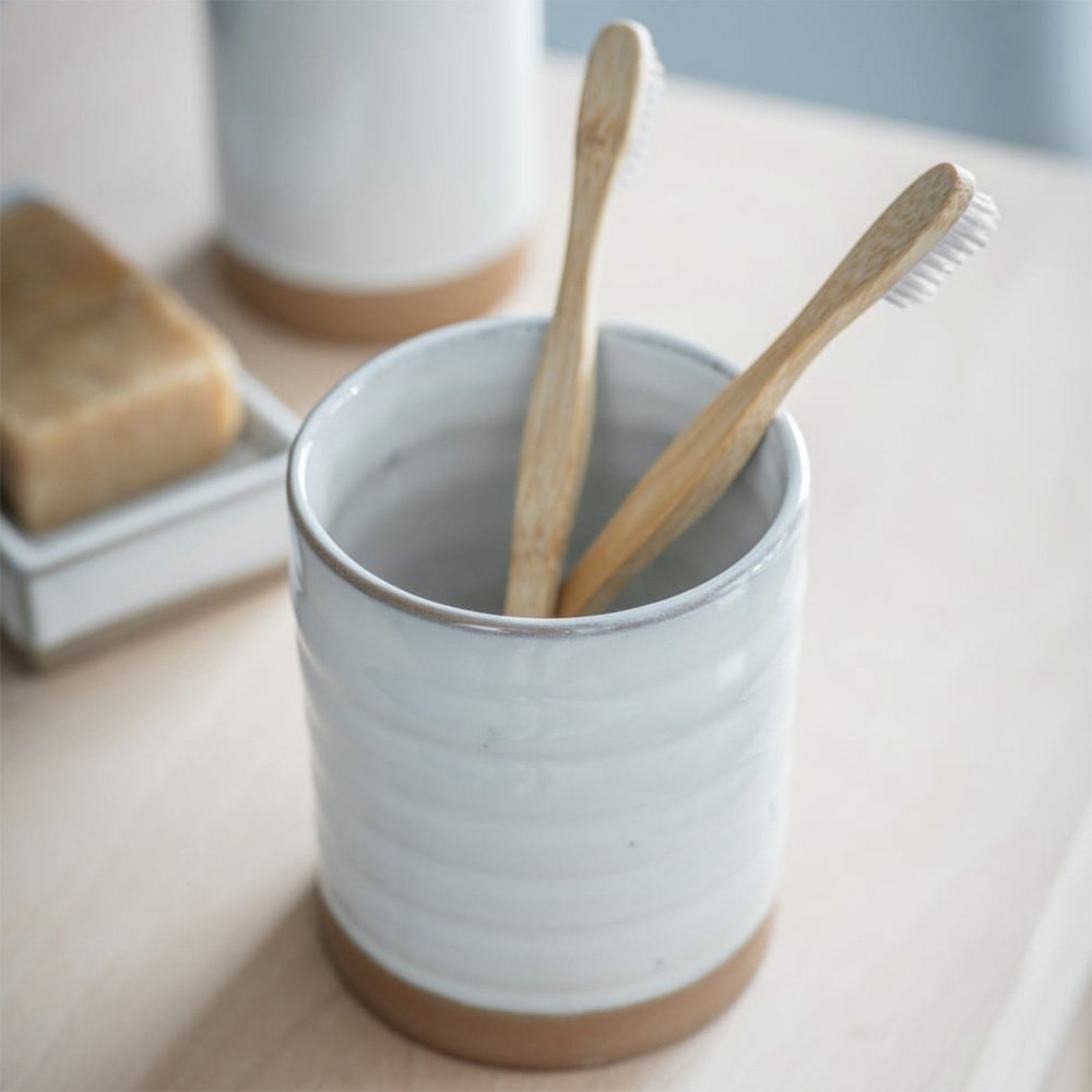 White ceramic toothbrush holder with terracotta base
