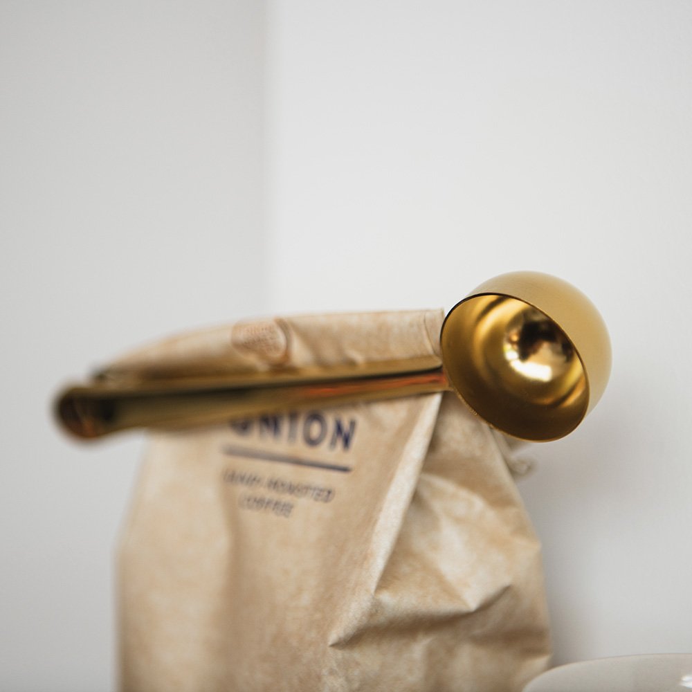 Close up of brass coffee scoop
