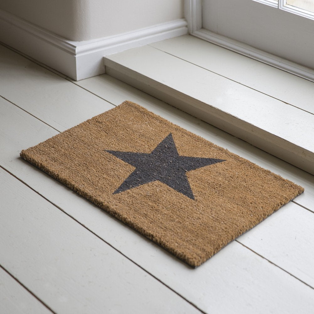 Tan brown coir doormat with black star in center