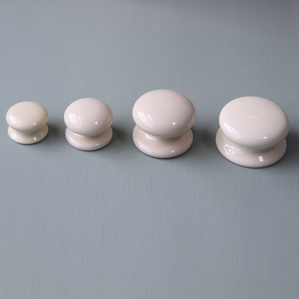 Cream Ceramic Cabinet Knobs Lined Up in Small, Medium, Large and Extra Large