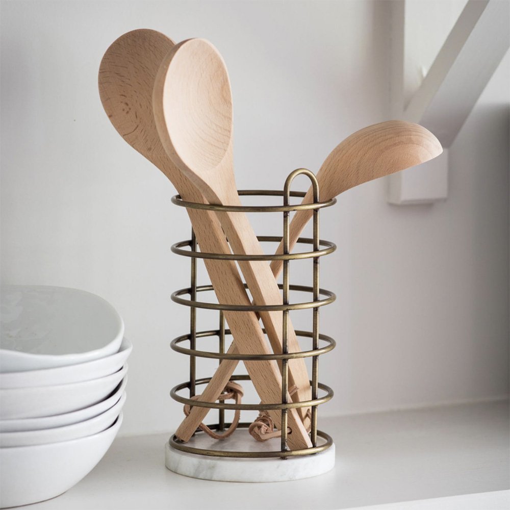 Cutlery holder displayed with wooden utensils featuring a marble base and bronze finish structure