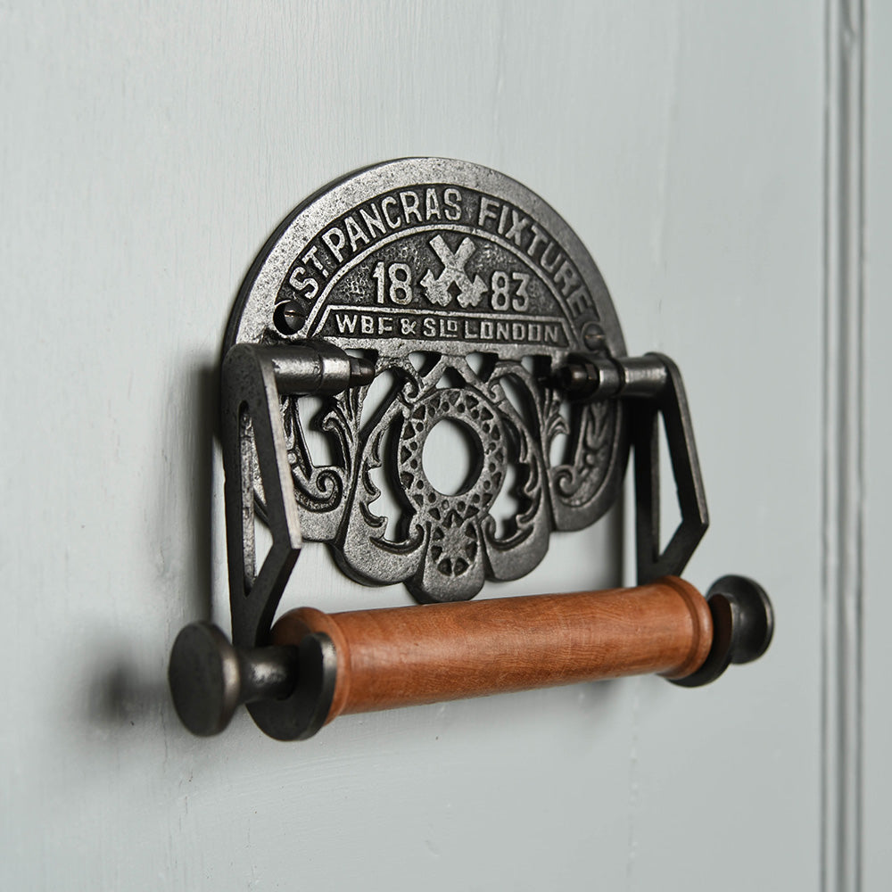 Decorative Cast Iron Toilet Roll Holder with Ornate 'ST PANCRAS FIXTURE' Text Plaque and Wooden Roller