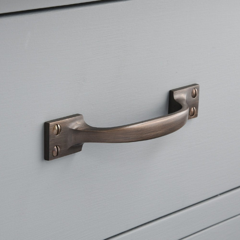angled picture of antique brass drawer handle