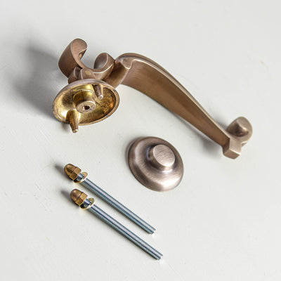 Light antique brass Doctors Door Knocker components including knocker, bolts and strike plate.