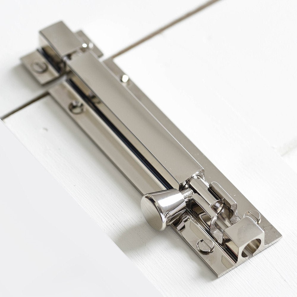 Solid brass Square Section Barrel Bolt in Polished Nickel plated finish on cupboard door.