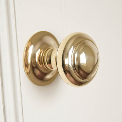Close up of Round 3 inch Door Pull in Polished Brass.