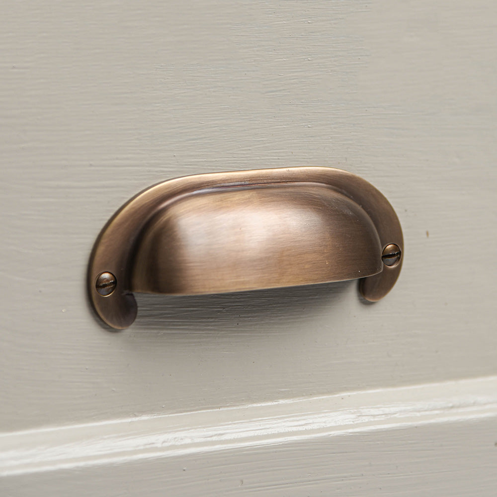 Large Curved Hooded Pull in light antique brass finish.