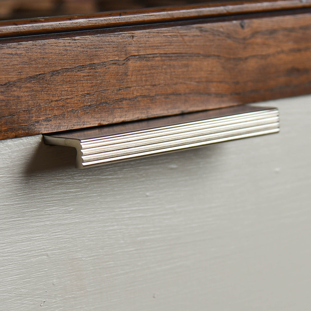 Solid brass Reeded Cabinet Edge Pull in Satin Nickel finish on drawer.