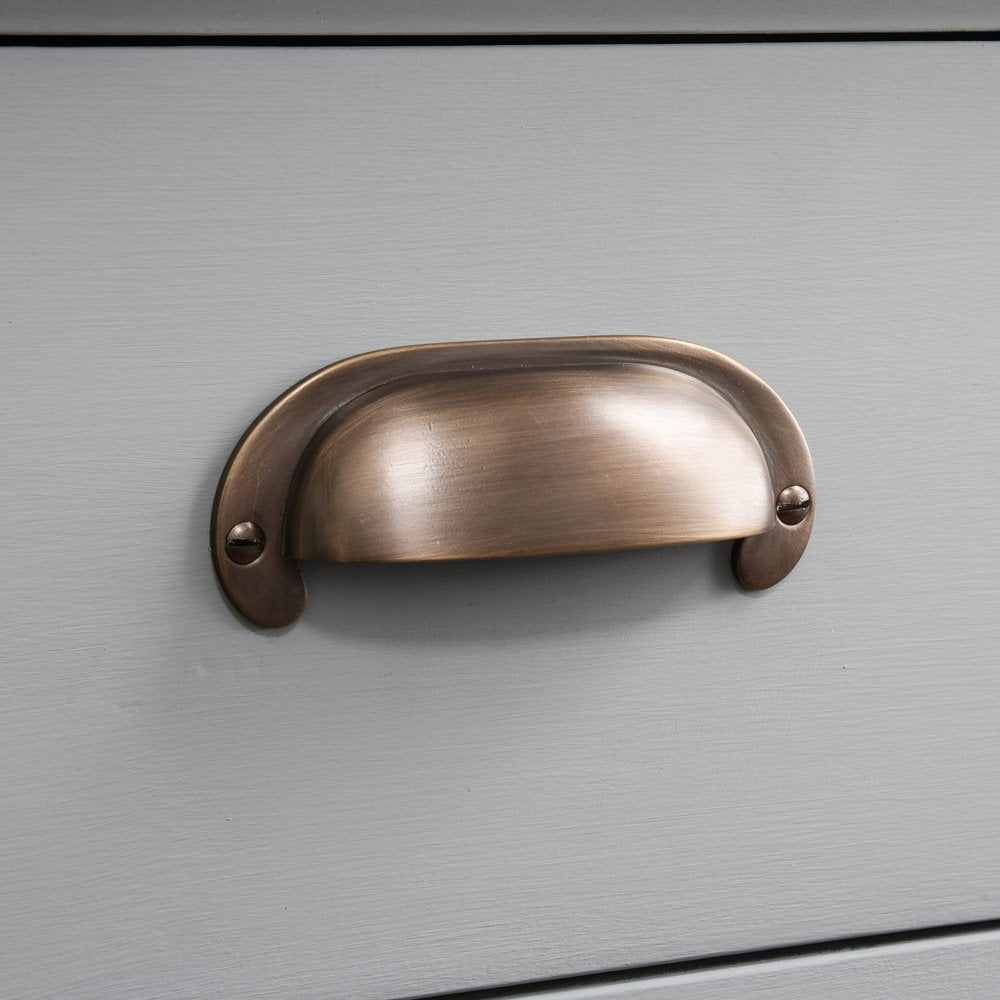 Large Curved Hooded Pull in distressed antique brass finish.