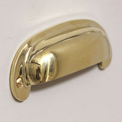 Side angle of Large Curved Hooded Pull in polished brass.