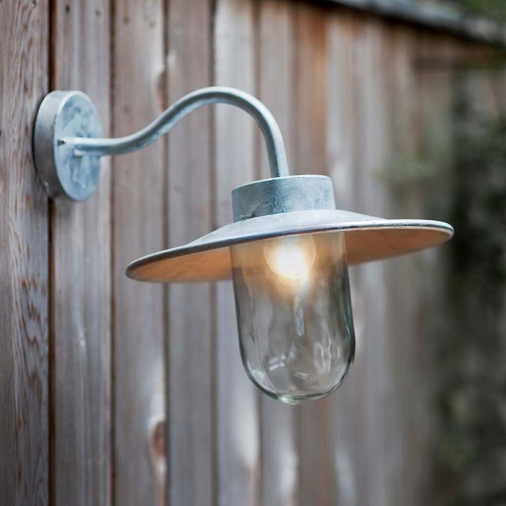 Arched swan neck wall mounted outdoor light in galvanised finish with clear glass shade