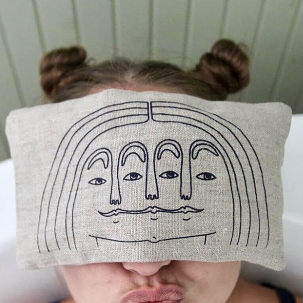 linen wheat filled eye pillow with face design in neutral colour