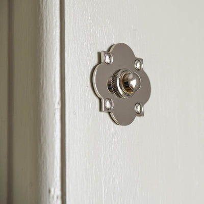 Solid brass Quatrefoil Bell Push plated with polished nickel mounted on cream wood.