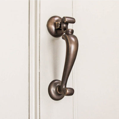 Solid brass Doctors Door Knocker with unlacquered distressed antique brass finish on Front Door