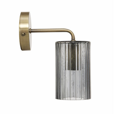 Side view of brass wall light with grey glass shade
