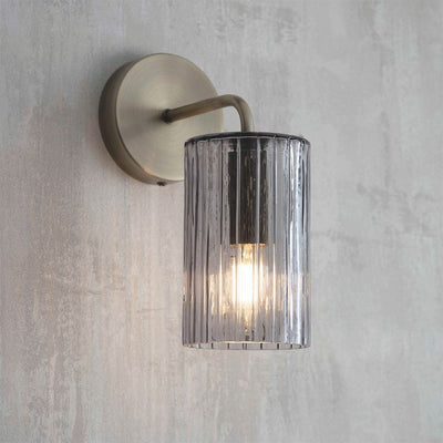 Brass wall light with grey glass shade
