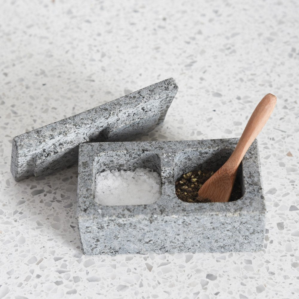 Rectangular raw granite pot with two compartments for salt and pepper. Complete with lid and wooden teaspoon.
