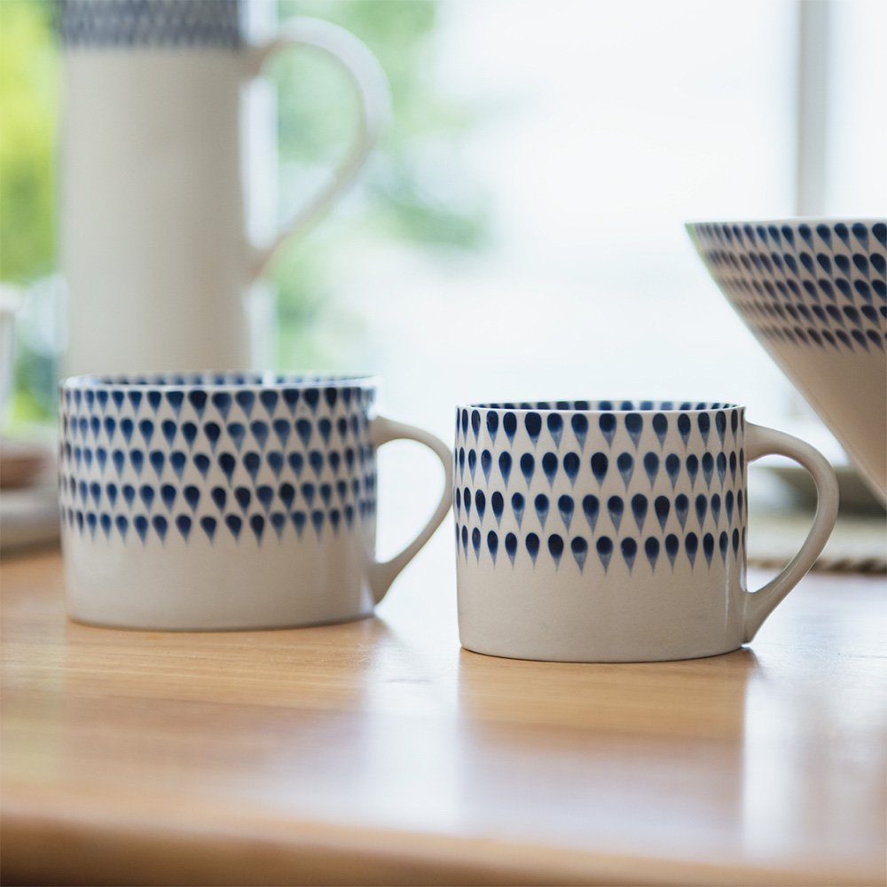 Two White & Blue Indigo Drop Design Ceramic Mugs on Table