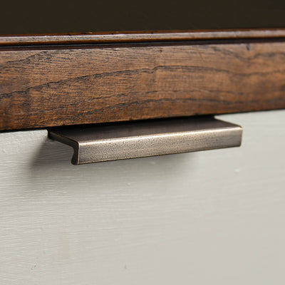 Flat Cabinet Edge Pull in distressed antique brass on drawer