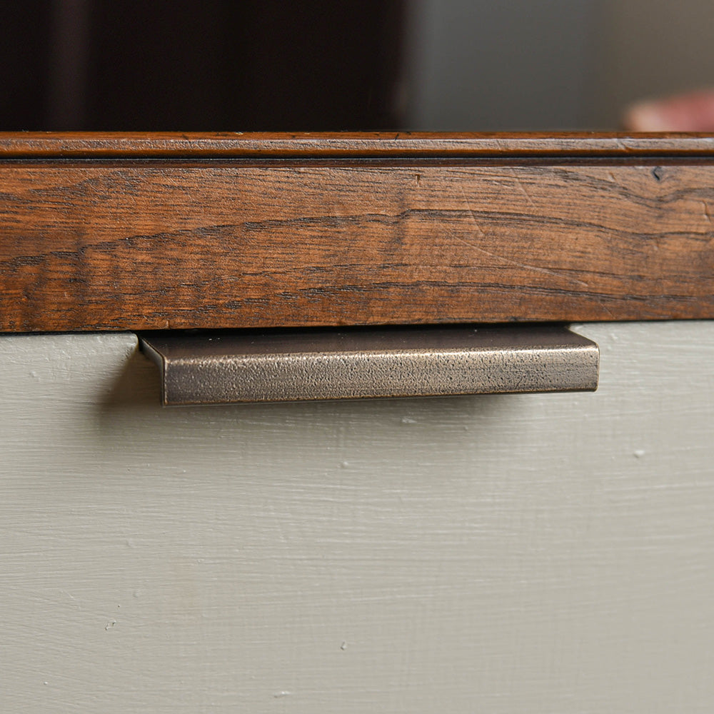 Alternative angle of Flat Cabinet Edge Pull in distressed antique brass.