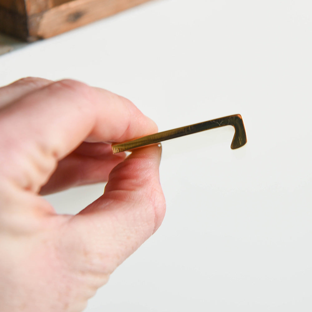 Solid brass Flat Cabinet Edge Pull held from the back.