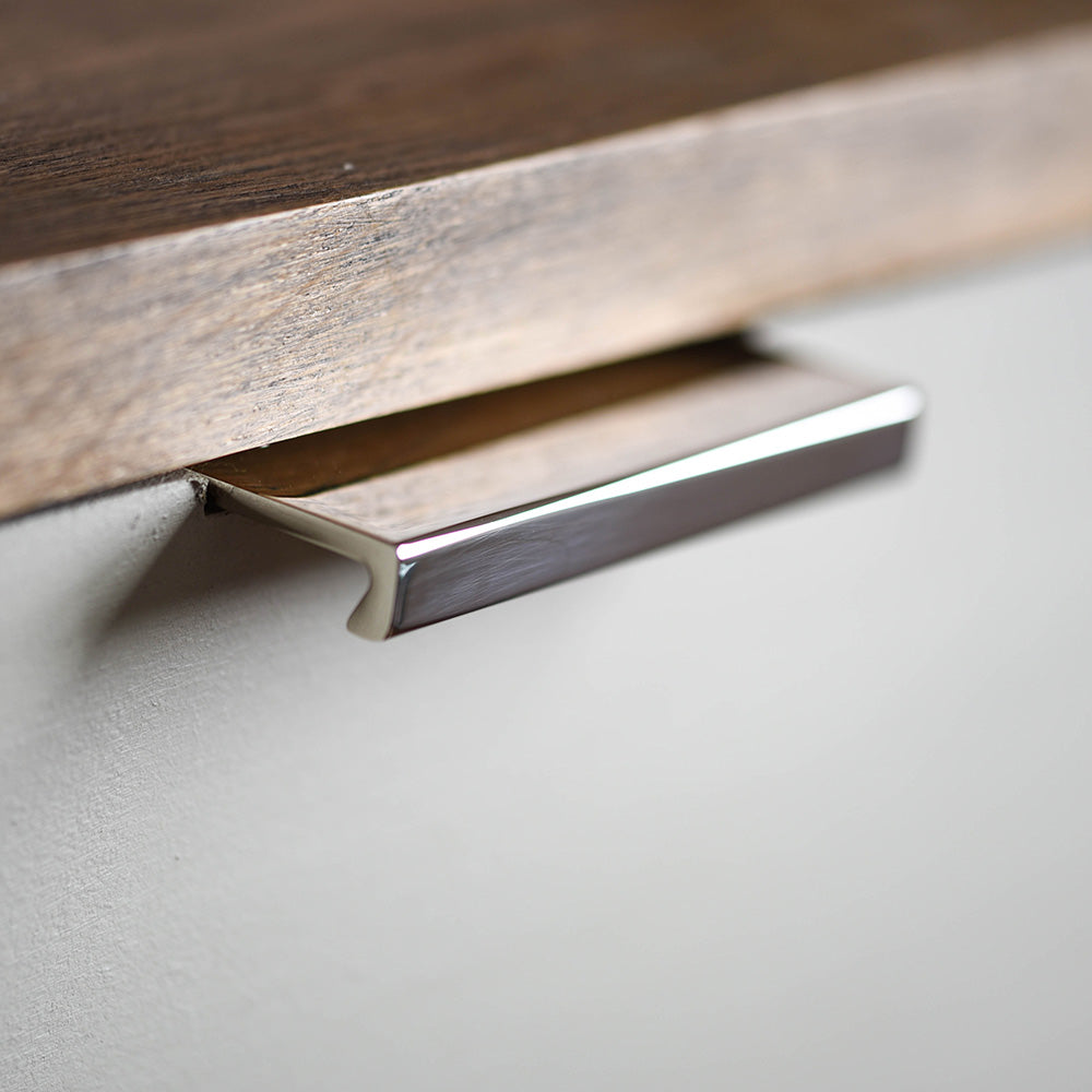 Flat Cabinet Edge Pull in polished nickel finish on drawer.