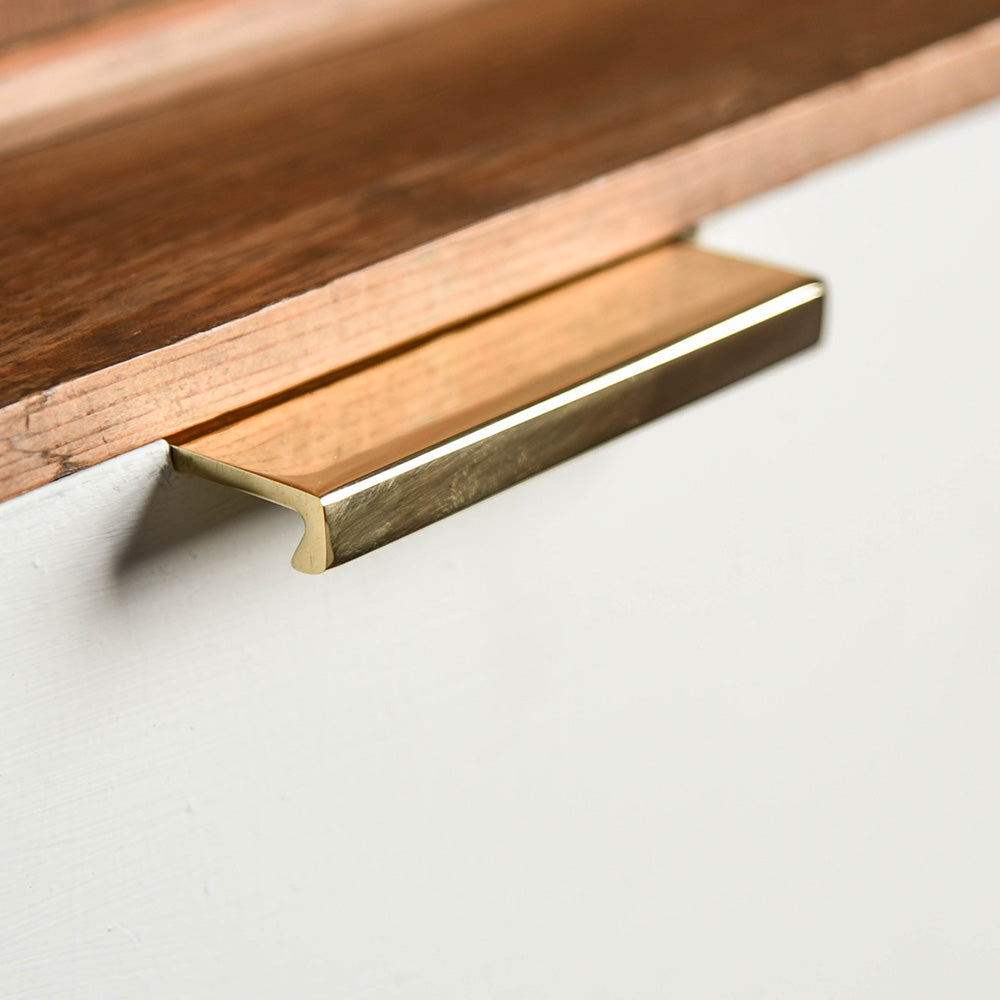 Solid brass Flat Cabinet Edge Pull on drawer.