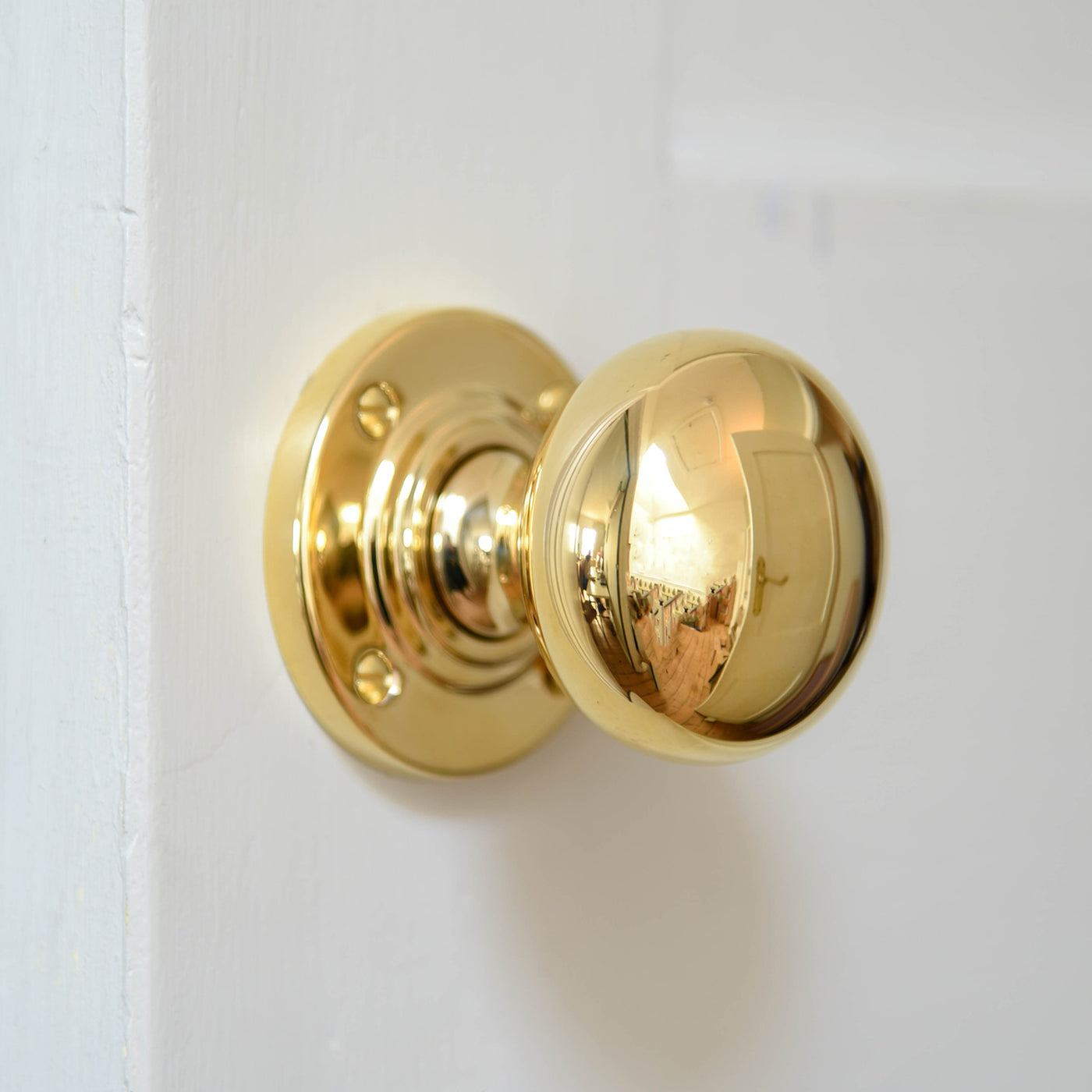 Large Bun Door Knobs in polished brass.