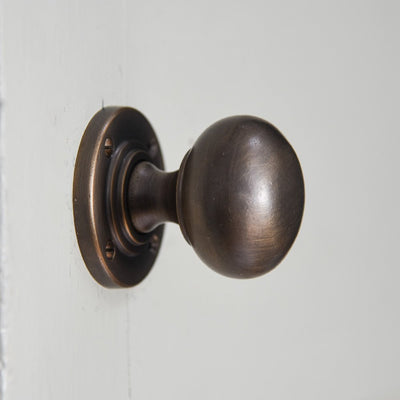 Solid brass Large Bun Door Knobs in distressed antique finish.