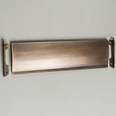 Components of Solid pressed brass Internal Letter Tidy in light antique finish.