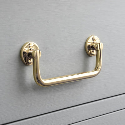 Lifting Drawer Pull Handle in Polished Brass on Blue Grey Drawer