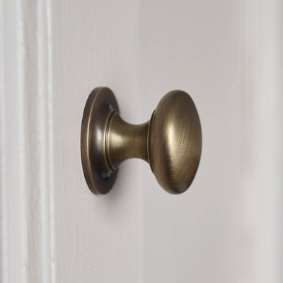Round Cabinet Knob in Light Antique Brass from Side