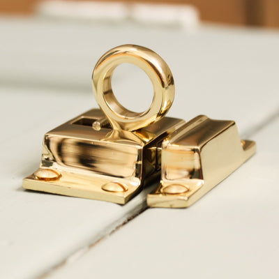 Top view of solid brass Ring Catch on cupboard door.