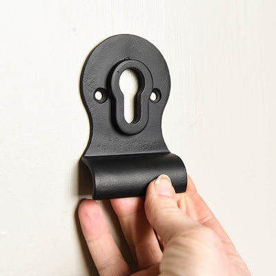 A Euro cylinder latch pull with a matte black finish