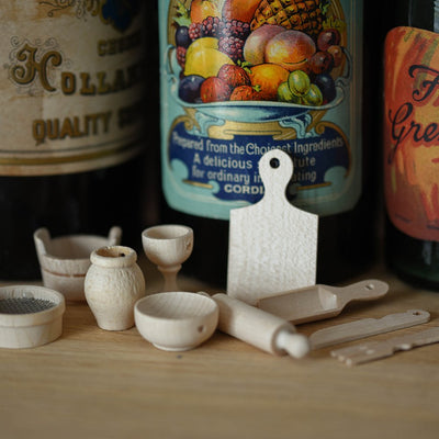 Miniature wooden kitchen accessories laid out