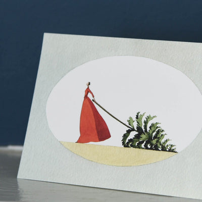 Laura Stoddart mrs christmas card close up of woman in red dress dragging tree