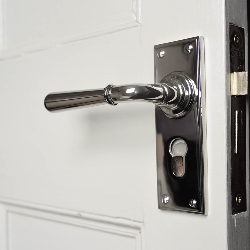 A Euro Newbury Lever Lock Handle in a polished nickel finish fiitted in place on a door