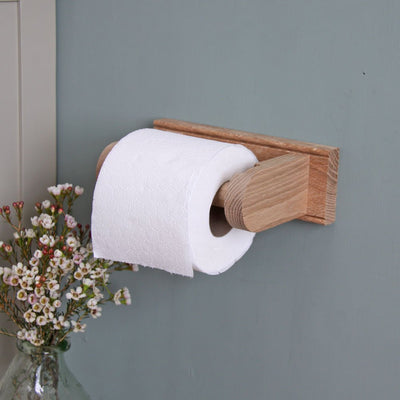 Solid oak loo roll holder with roll attached