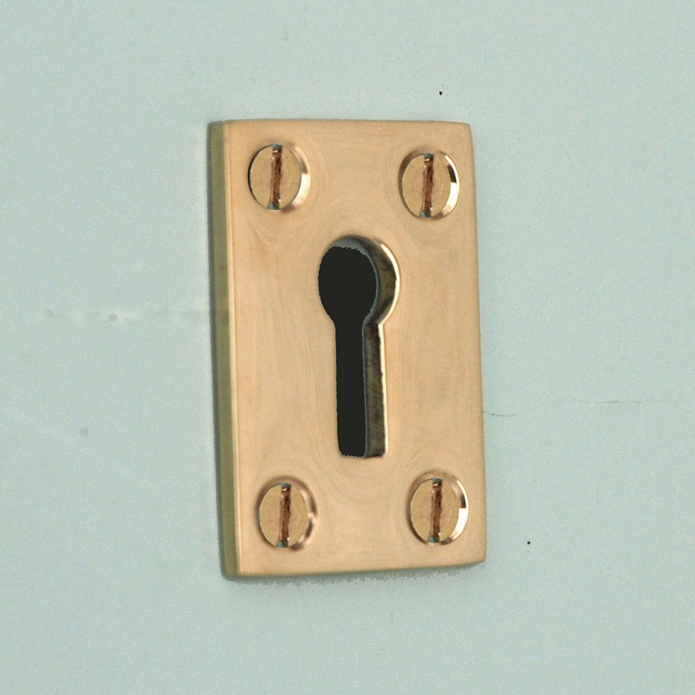 Brass Oblong Keyhole Escutcheon on blue green door