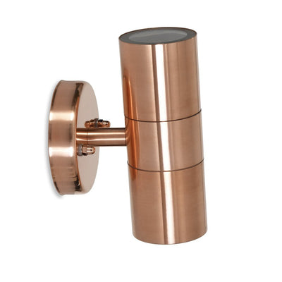 Studio image of raw copper wall mounted outdoor up and down light in simple cylindrical design