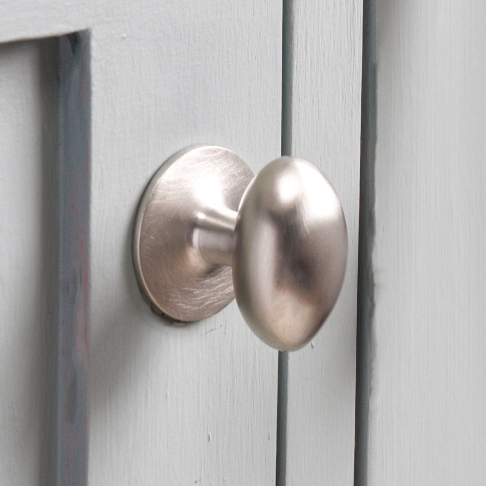 Close up of Oval Satin Nickel Cabinet Knob on cupboard door.