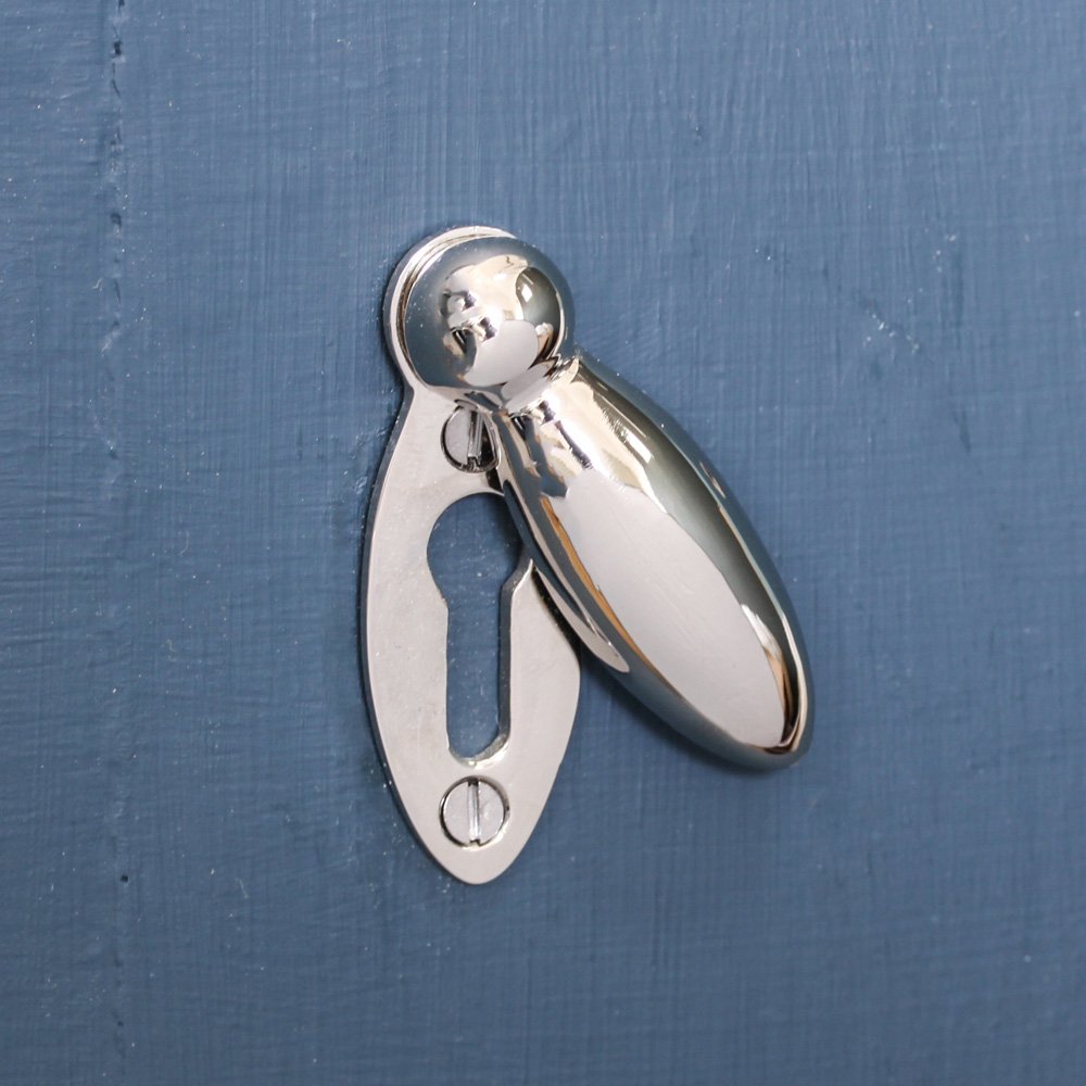 Keyhole escutcheon with a swing cover