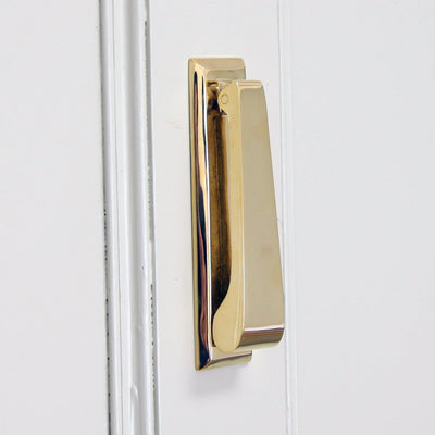 Solid brass slim vertical door knocker on a rectangular backplate