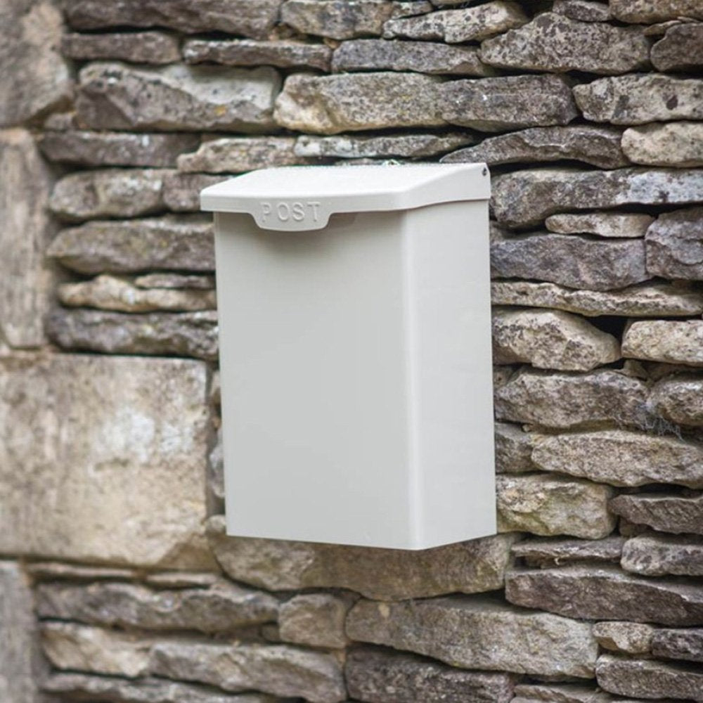 Wall mounted off-cream post box with 'post' embossed in capital letters across front of lid