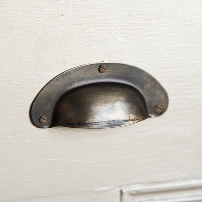 Pressed Brass Drawer Cup Handle in Aged Finish