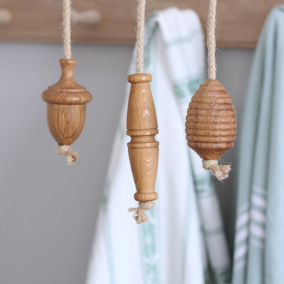 Solid oak light pulls in 3 styles Acorn, Toggle and beehive displayed on ropes